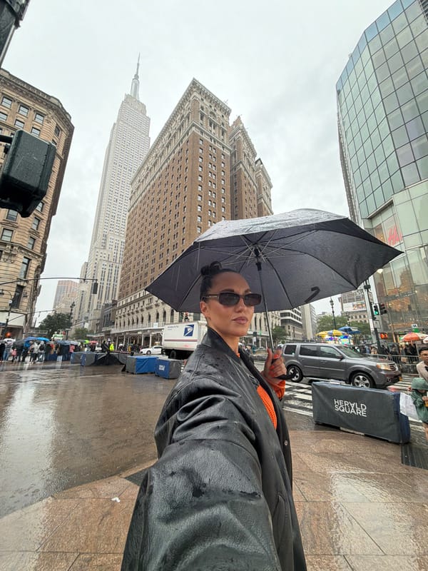 Person with umbrella spotted in rain near Empire State Building