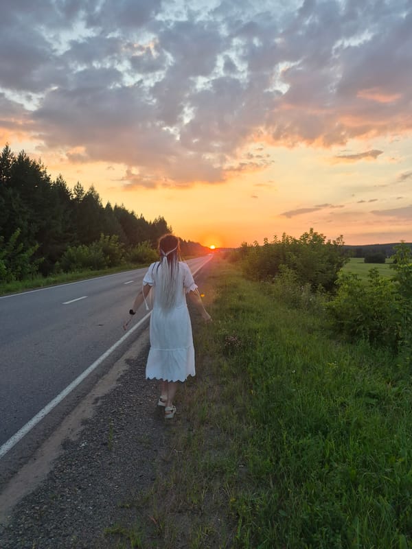White dress, braided hair, golden hour on a Russian country road
