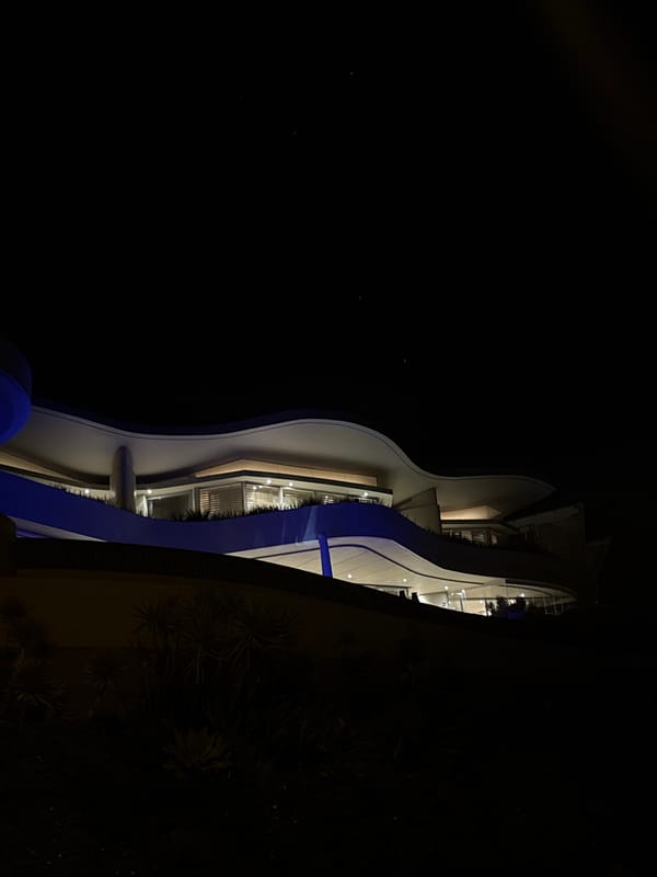 Cape Town evening scenes captured: illuminated building, ocean sunset