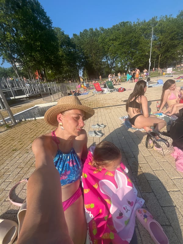 Crowded outdoor pool on a sunny afternoon, ladybug included