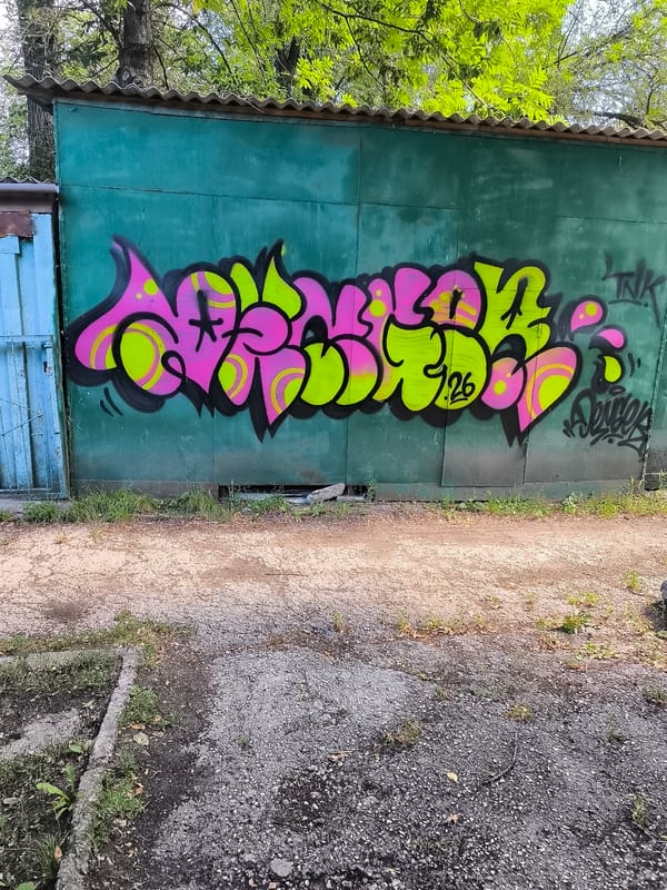Graffiti-tagged garages and Soviet-era signage in Bălți, Moldova