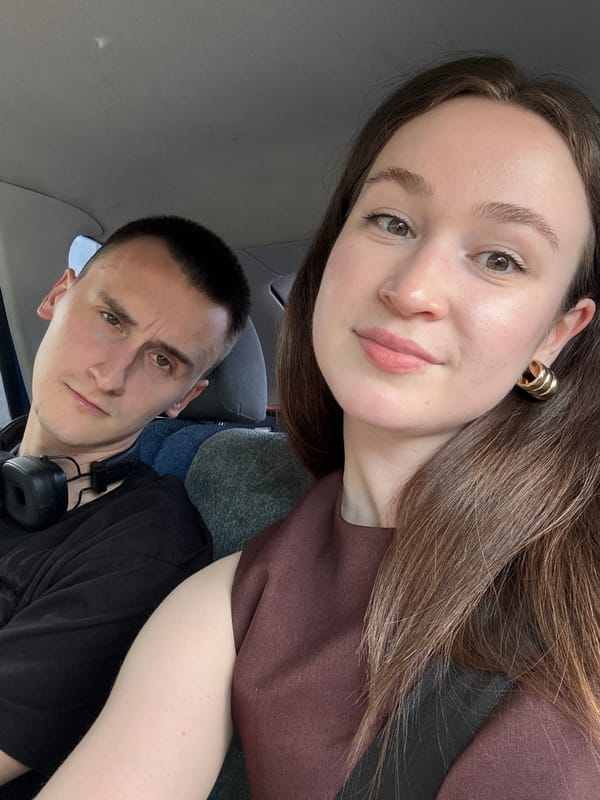 Inside a car and holding a quirky dog statue, Perm