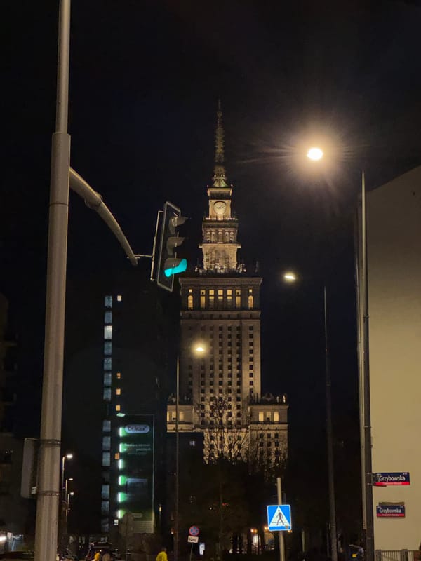 Full moon photographed above Warsaw's Palace of Culture