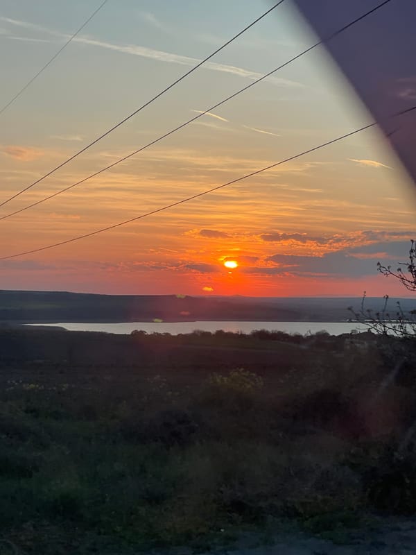 Sunset observed over Burgas landscape with power lines, roads