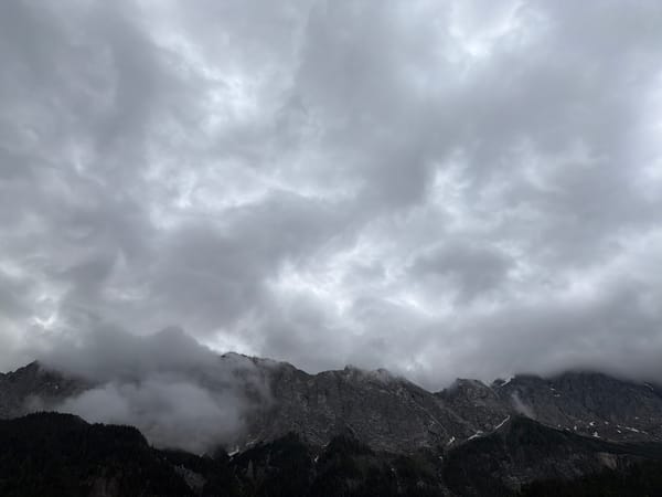 Morning clouds shroud rocky peaks in Grainau, Germany