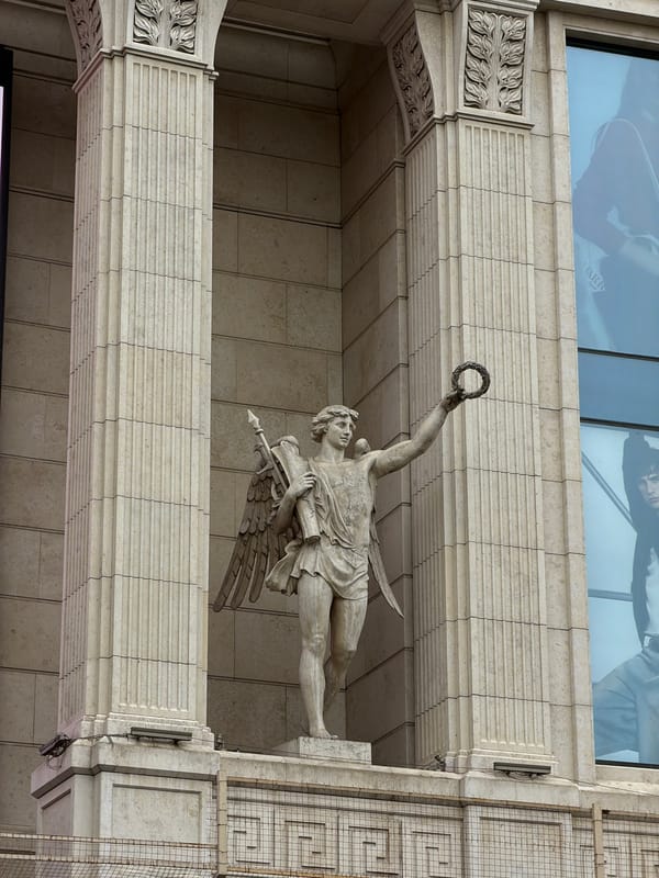 Traffic officer directs pedestrians near historic statues in Saint Petersburg
