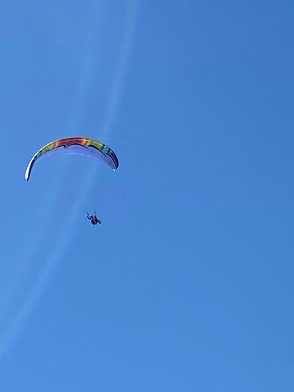 Paraglider soars over Boreti, Montenegro in clear skies