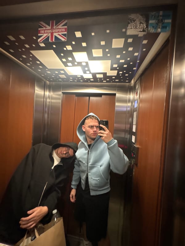 Two men take elevator mirror selfie in Plovdiv