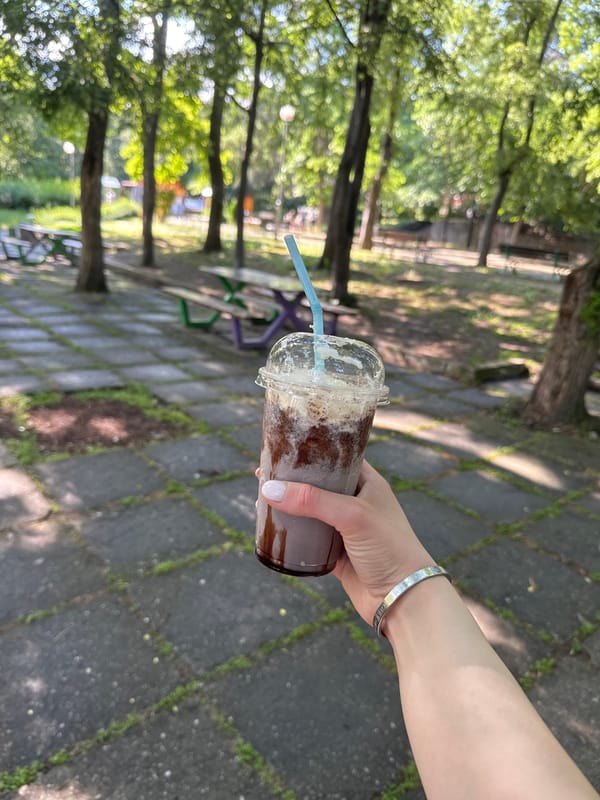 Person enjoys layered drink outdoors in Plovdiv, Bulgaria