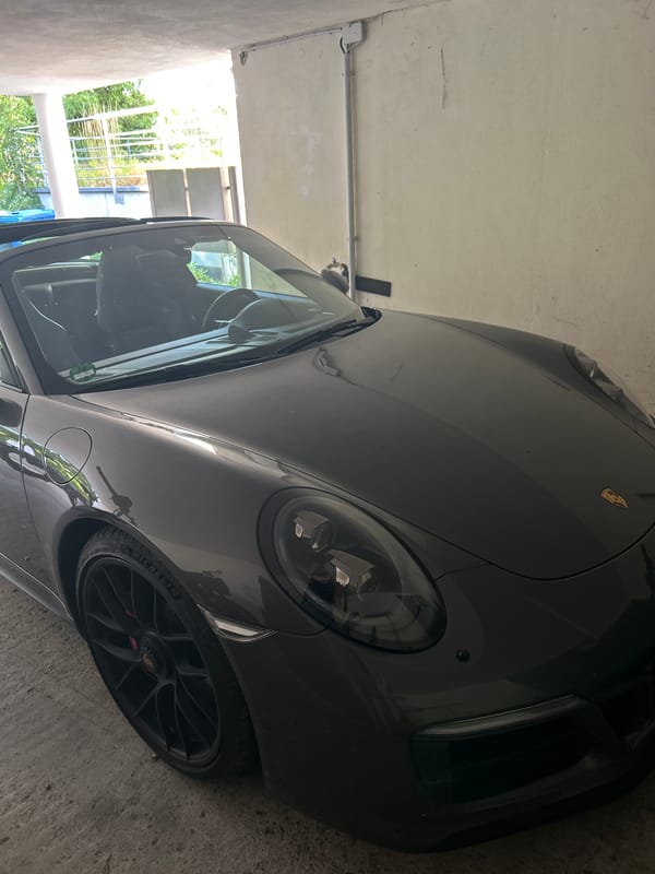 Grey Porsche Targa and e-bike share a garage