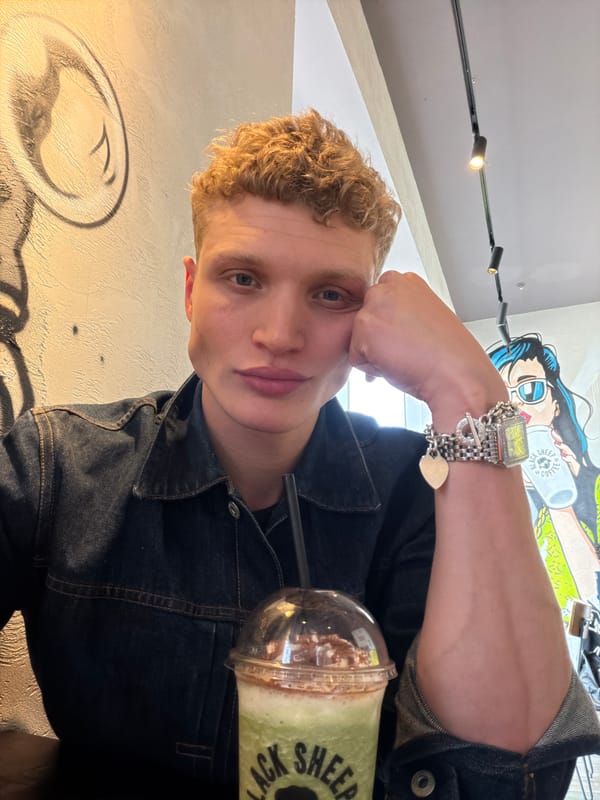 Coffee shop patron enjoys matcha latte at London cafe