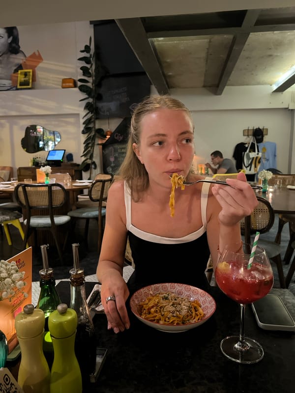 Woman enjoys pasta lunch at Bangkok restaurant