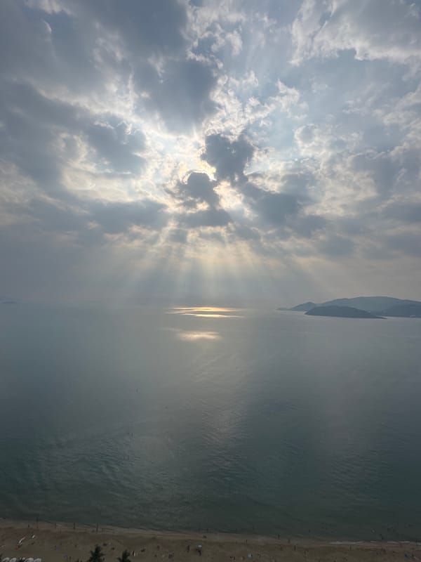 Dramatic sunbeams pierce clouds over coastal waters May 14