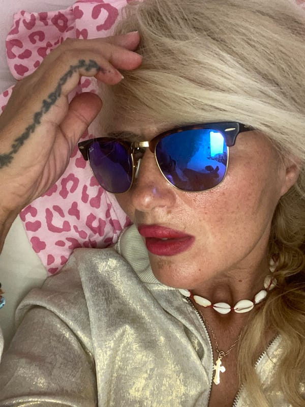 Relaxed Santorini afternoon, shell necklaces and mirrored shades