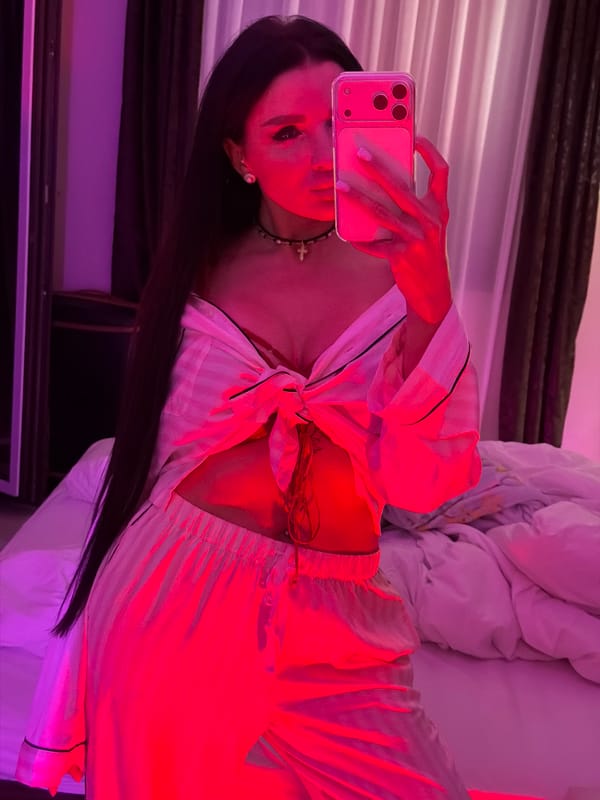 Mirror selfie taken in colorfully lit room in Montenegro