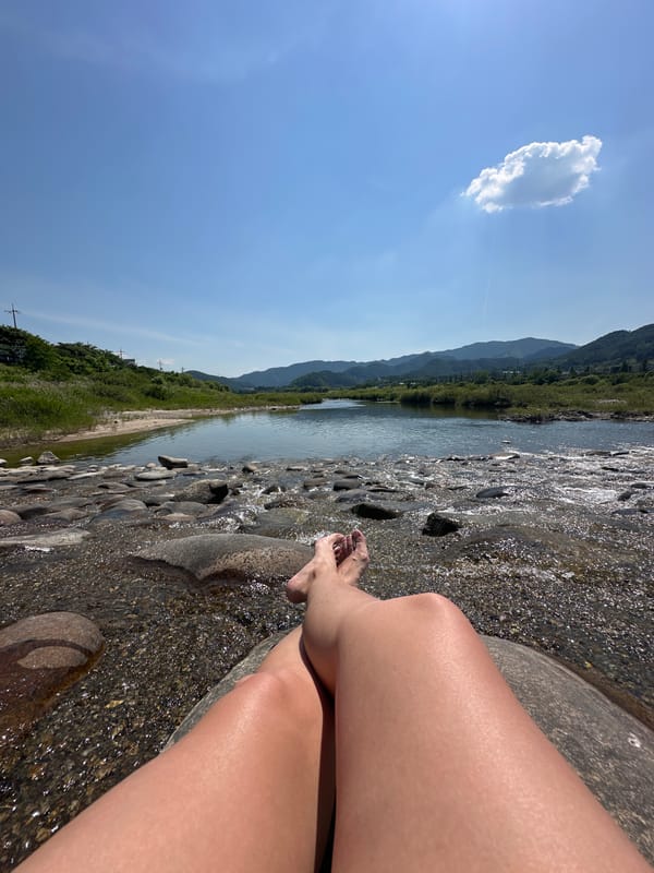 Person rests by clear river in South Korea