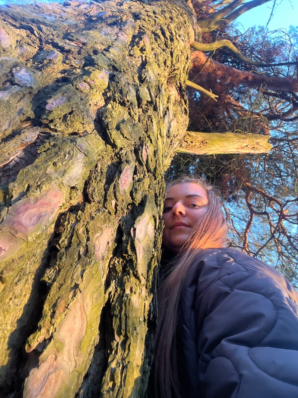 Woman photographed resting against tree in Zaovrazh'e, Russia