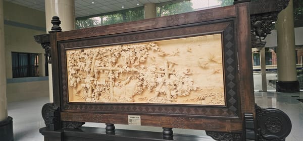 Ornate wood carving with grape vines observed in Yuzhong District