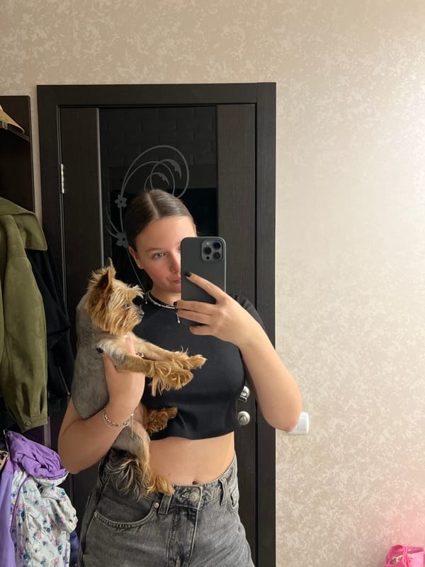 Woman takes selfies with Yorkshire Terrier in Chaikovsky apartment