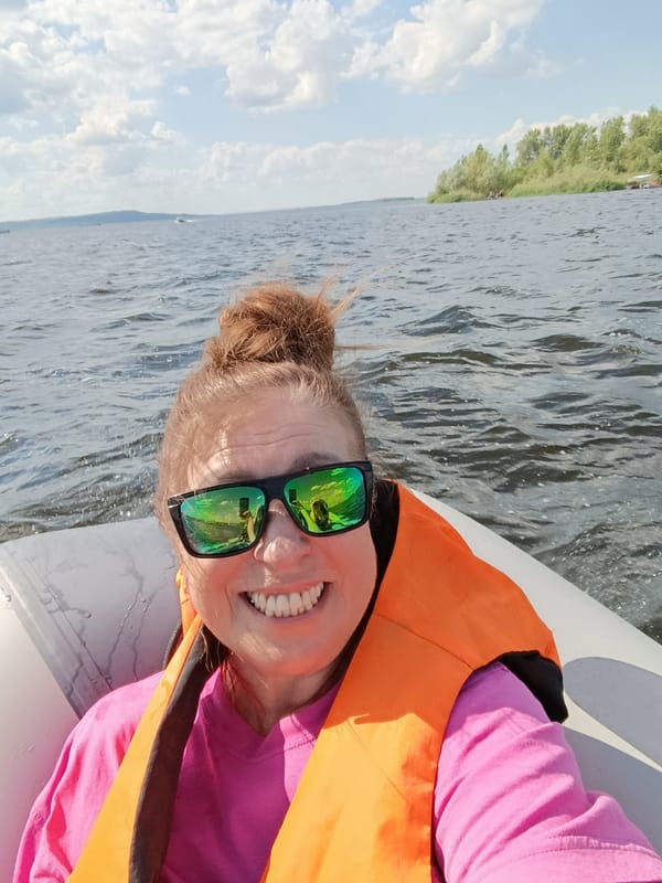 Inflatable boat outing on choppy water near a wooded shore