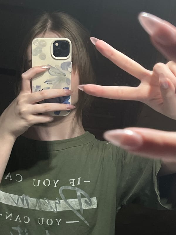 Mirror selfie session in Ashkadar captures green shirt and personal items