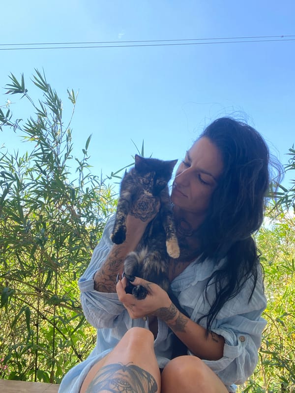 Tattooed woman photographed with cat in Mũi Né, Vietnam
