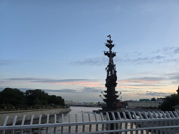 Sailing ship monument at dusk near a city street