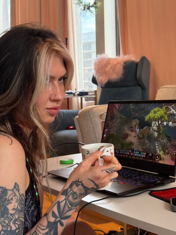 Tattooed gamer enjoys coffee break with flamingo mug in Budva
