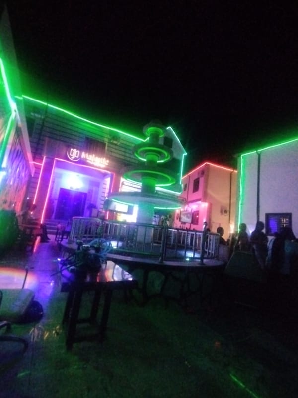 Nighttime entertainment venue with neon lights captured in Tumfure, Nigeria