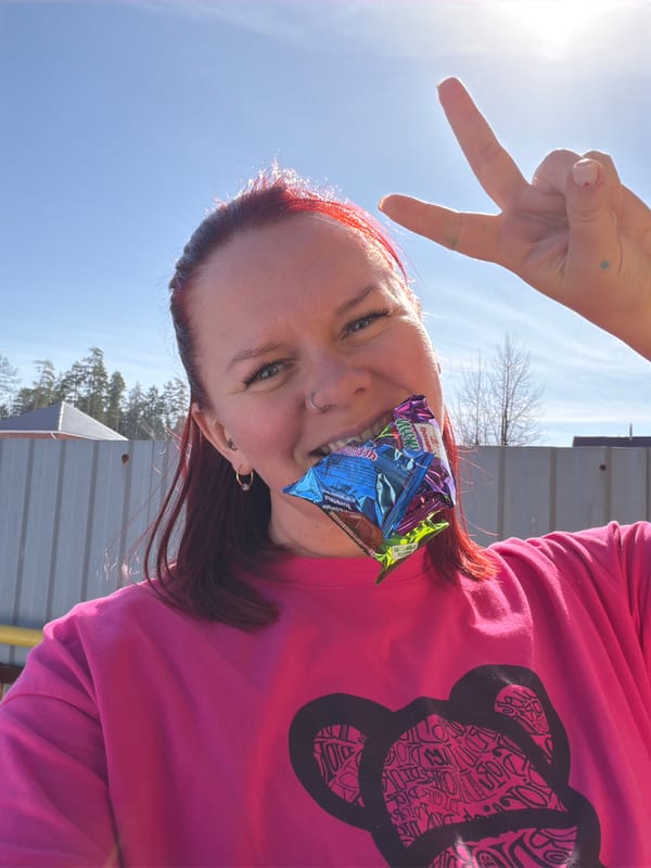 Woman poses with candy, food display in Chaikovsky