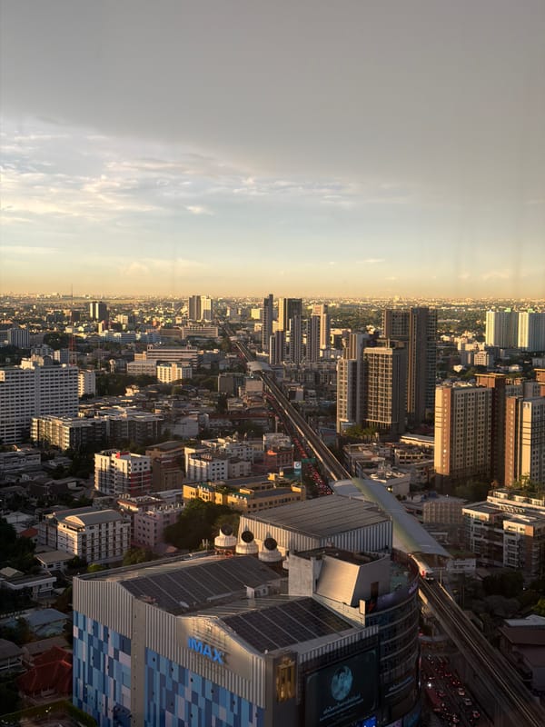 Bangkok cityscape from above, glowing in hazy golden light