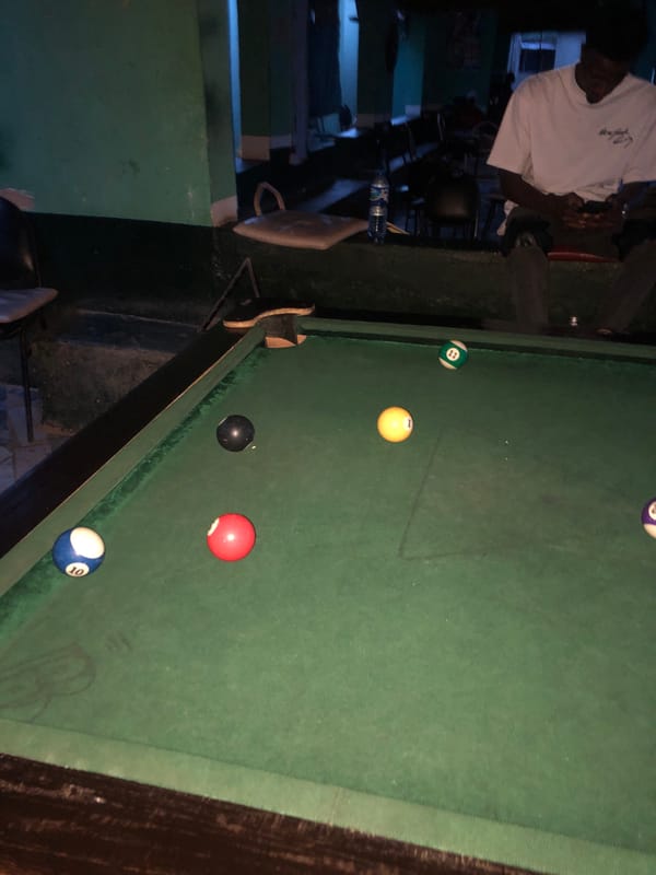 Pool hall documented in low-light indoor setting