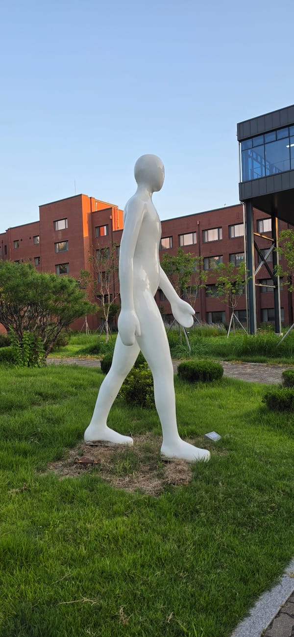 Strolling a sculpture-dotted campus in Cheongju at golden hour