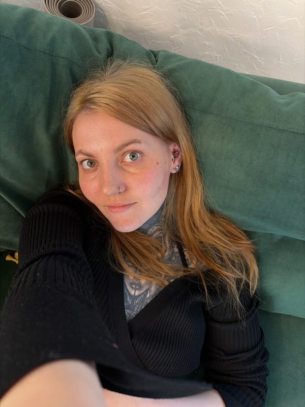 Woman relaxes on green sofa in Russian home