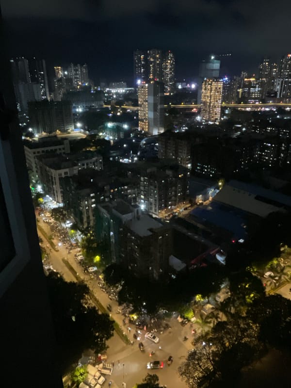 Mumbai high-rise and rooftop pool, cloudy afternoon into dusk