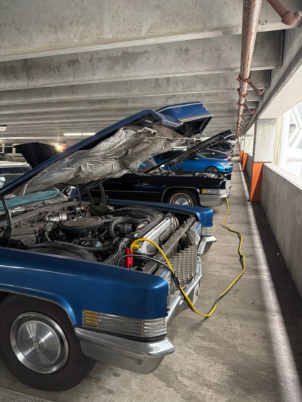Vintage blue Cadillac Eldorado with hood up in LA parking garage