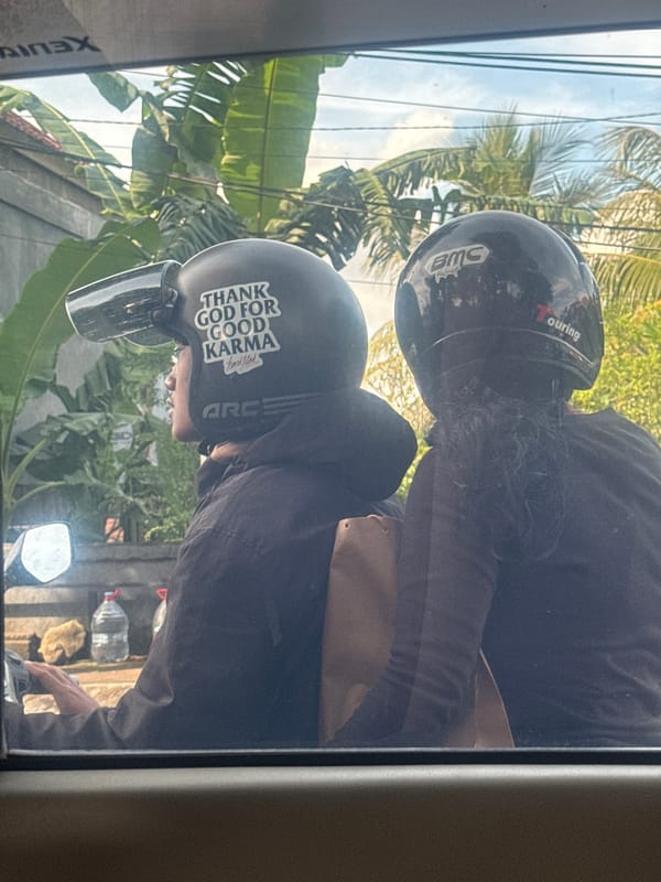 Two scooter riders spotted on Gianyar street through window
