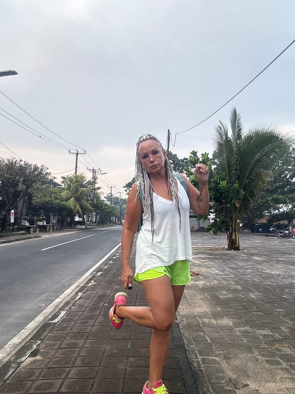 Woman observed on wet Kuta sidewalk during evening hours