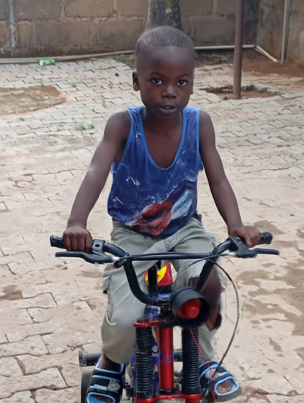 Children play with bicycles in Nigerian neighborhoods