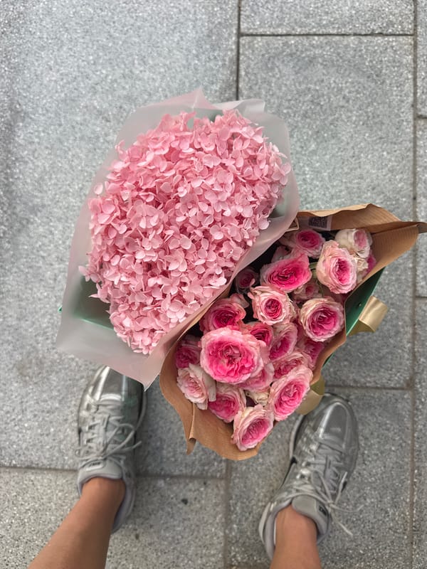 Pink flower bouquets placed on Dubai sidewalk