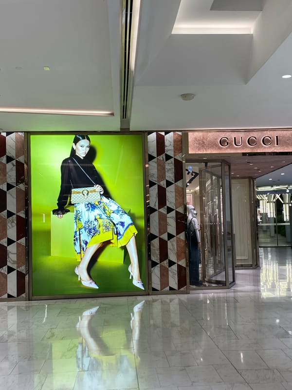 Gucci store display observed in Bangkok featuring illuminated advertisement
