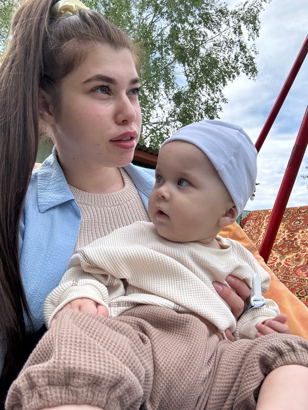 Family gathering with baby and dogs photographed in rural Russia