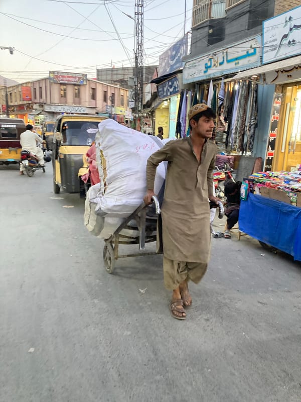 Man pulls package-laden handcart through Quetta streets