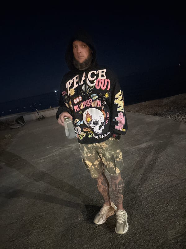 Person in casual wear stands on pavement in Bar, Montenegro