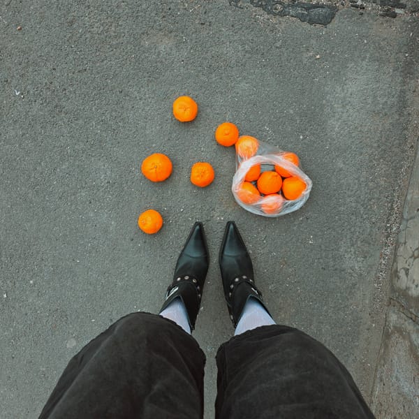 Oranges scattered from bag on Saint Petersburg street