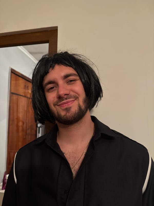 Man in black wig photographed smiling in Yerevan