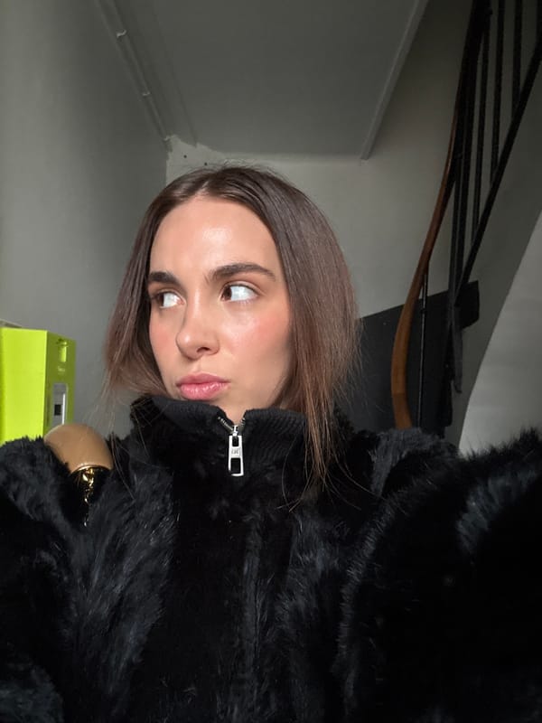 Woman photographed in black coat at Paris indoor locations