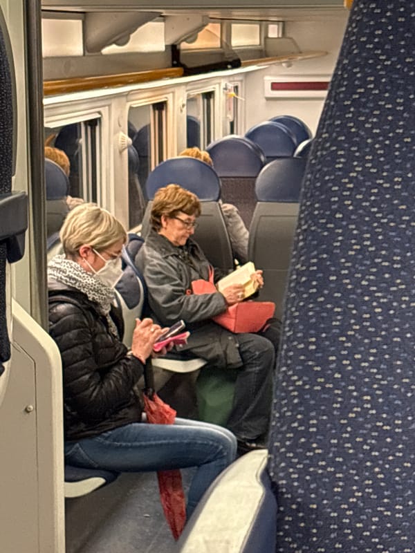 Passengers rest on Milan train during afternoon journey