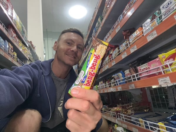 Man shops for snacks, takes selfie in Sukawati grocery store