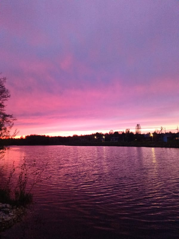 Pink and purple sunset observed over water in Красный Маяк